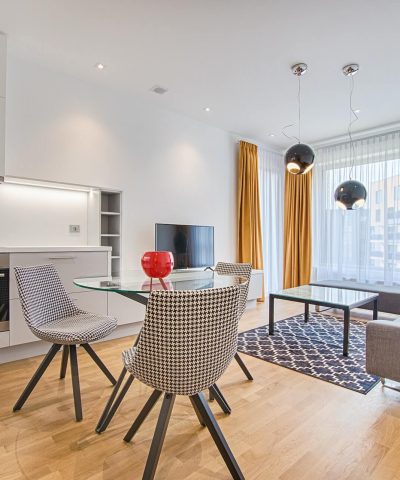 two chairs with glass table on living room near window